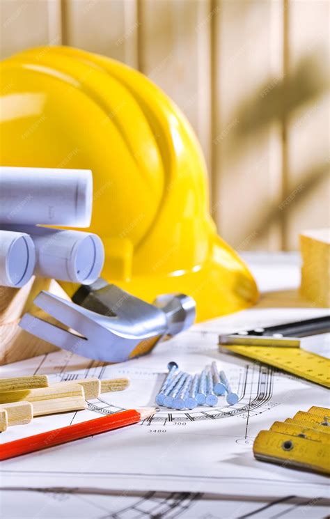 Carpentry tools on table with blueprints | Premium Photo