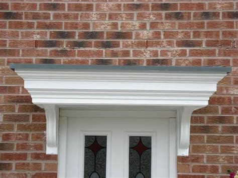 a white door with two glass panes on the side of a brick building next ...