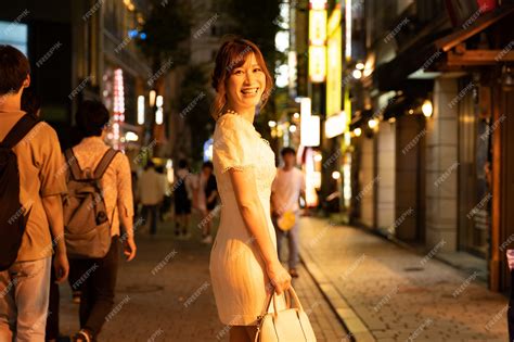 Japanese woman with glamorous white dress in the streets of tokyo ...