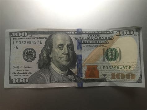 Value of $100 bill with security strip cuts slightly off : uspapermoney