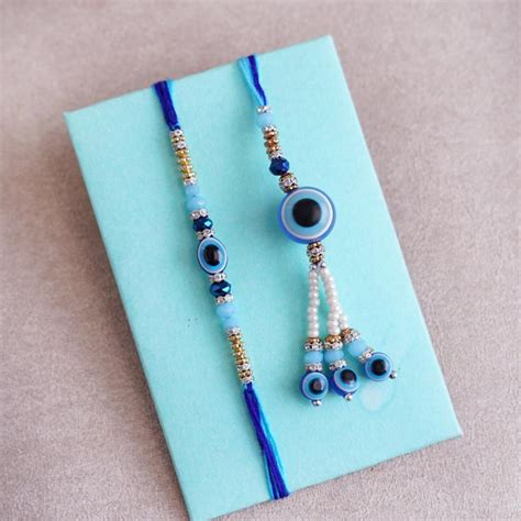 Send Evil Eye Bhaiya Bhabhi Rakhi with Almond Tray Online | Rakhibazaar.com