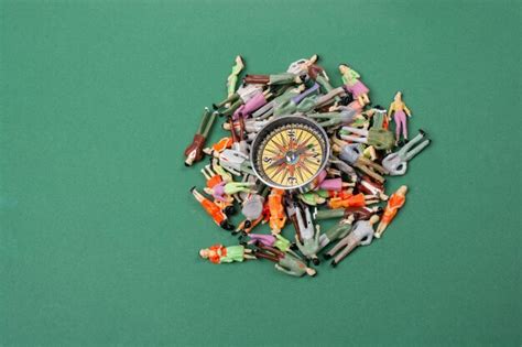 Crowd of miniature people figurine around a compass | Premium Photo