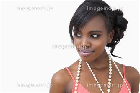 Smiling woman wearing a pearl necklace on white backgroundの写真素材 ...