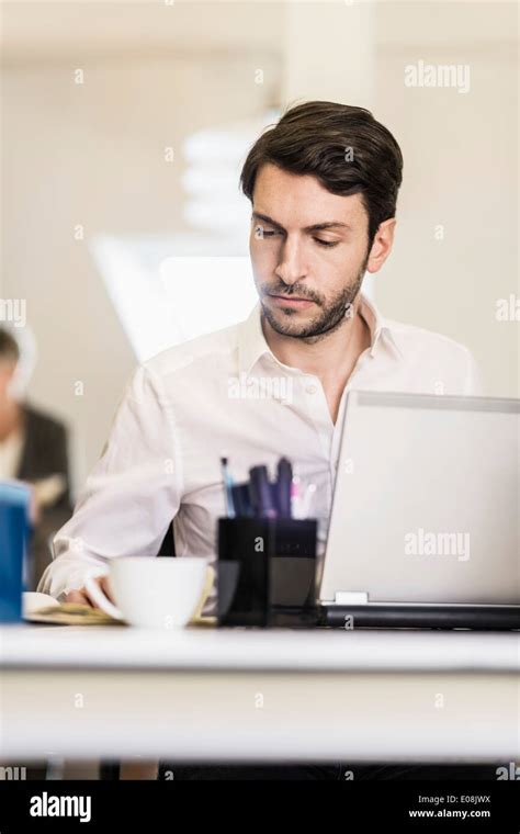 Businessman Working at Desk 的图像结果