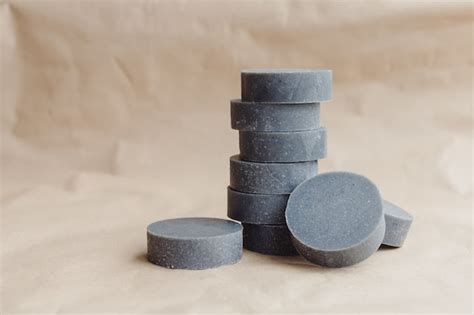 Stack of handmade solid shampoo and conditioner bars on paper ...