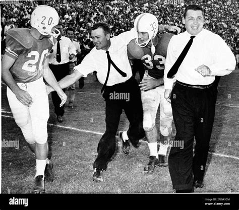 Texas coach Darrell Royal congratulates two of his players as they ...