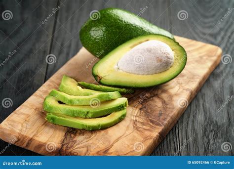 Sliced Ripe Avocados on Olive Cutting Board Stock Photo - Image of ...
