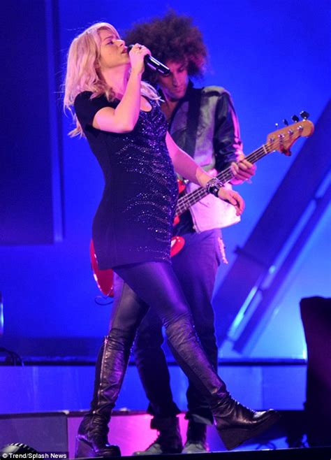Shakira shows off her growing shape on stage as the pregnant star gives ...