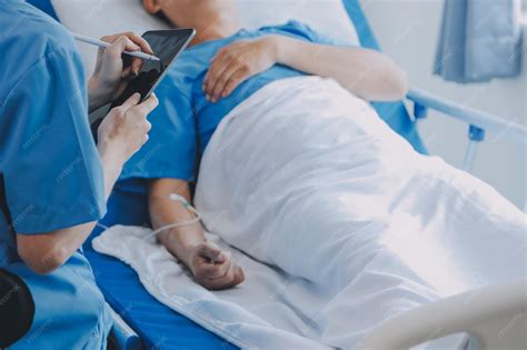 Injured patient showing doctor broken wrist and arm with bandage in ...