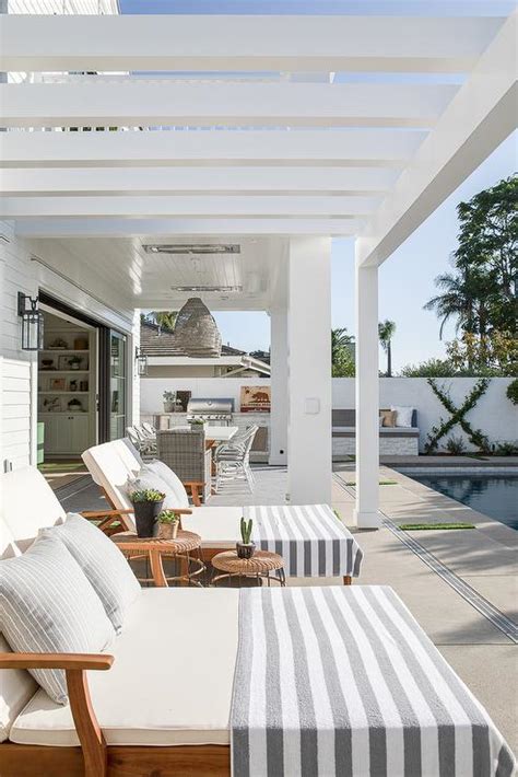 https://cdn.decorpad.com/photos/2022/01/03/white-pergola-over-pool-loungers.jpg