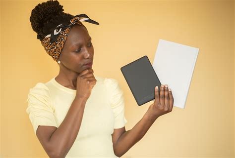 Young woman trying to decide between printed book vs e-book. | Premium ...