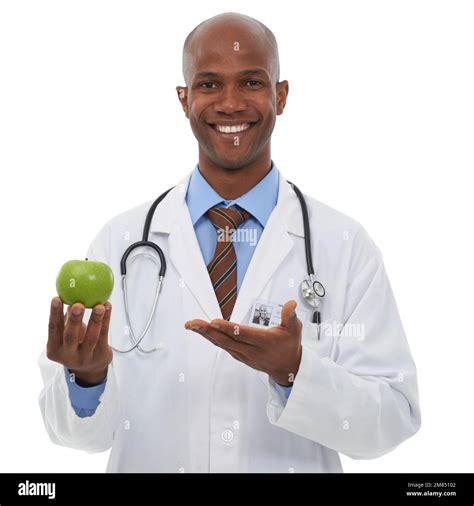 Stay healthy by eating fruit. Cropped image of a young african doctor ...