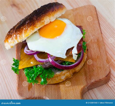 Hamburger with Fried Egg, Bacon, Cheese, Lettuce, Onion Stock Photo ...