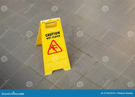 Yellow Caution Slippery Wet Floor Sign Showing and Warning of Caution ...