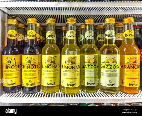 Chionotto, lemonade, and orange soda by Lurisia in bottles displayed in the refrigerator ...
