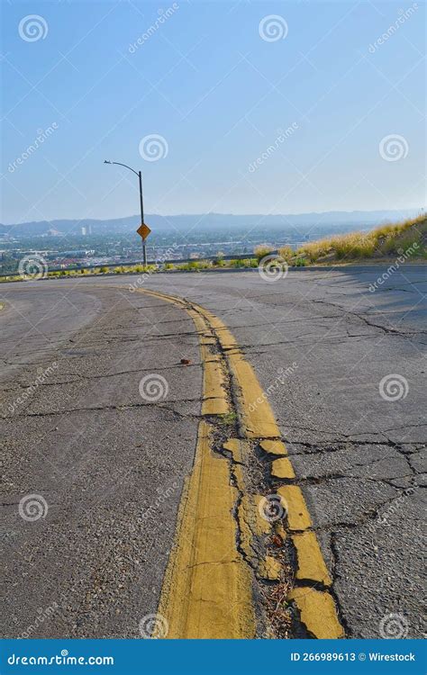 Vertical Shot of Yellow Centerline on Cracked Asphalt Road Under Blue ...