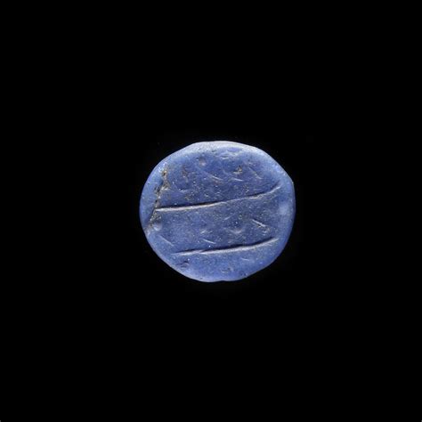 AN EARLY ISLAMIC GLASS WEIGHT OF QUARTER DIRHAM, 10TH-11TH CENTURY