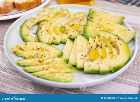 Ripe Avocado Pulp Cut into Pieces Sprinkled with Lemon Juice on a Plate ...