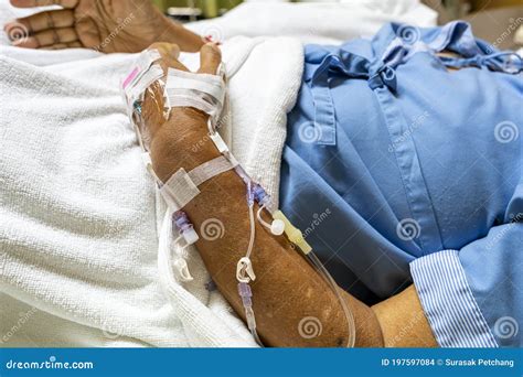 Selective Focus on Arm and Drip Tube of a Patient or Case in Hospital Ward Lie on Bed during ...