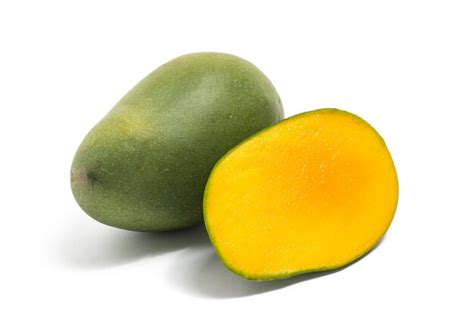 Half cut and whole fresh organic green mango delicious fruit side view ...