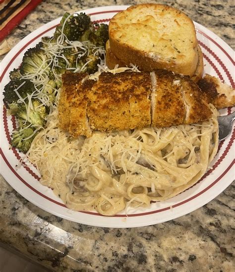 Fettuccini alfredo topped with crispy parmesan chicken, cheesy Texas ...