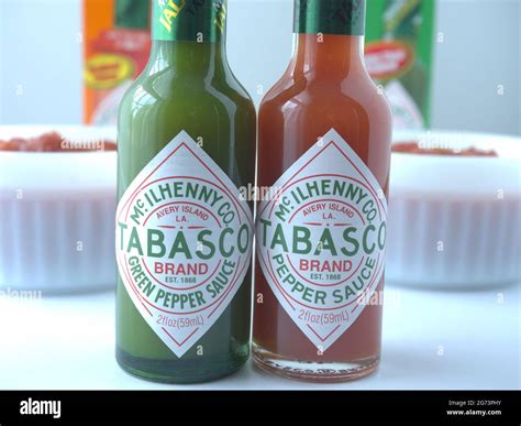 Red and Green Tabasco sauce with two bowls of salsa Stock Photo - Alamy