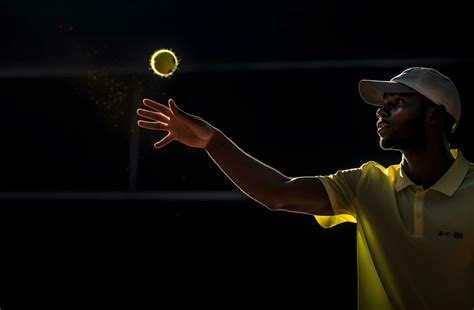 african american tennis player in cap and yellow uniform playing tennis ...