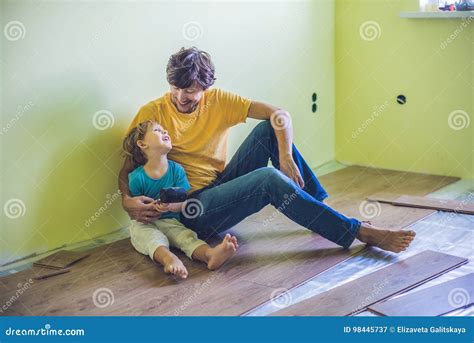 Father and Son Installing New Wooden Laminate Flooring. Infrared Stock ...