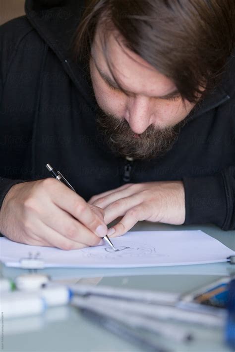 "Man Drawing On Table" by Stocksy Contributor "Robert Kohlhuber" - Stocksy