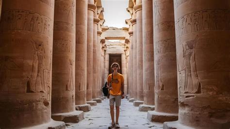 A young tourist entering the temple of edfu in the city of edfu egypt ...