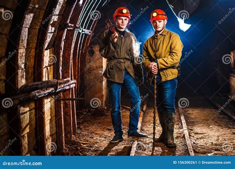 Two Miners In The Mine. Girls In Red Helmets And Lanterns In A Coal Mine. Coal Mine Work Plan ...