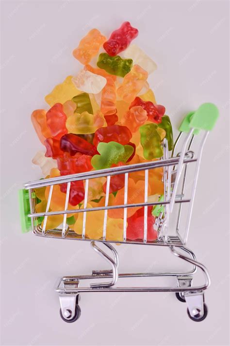 Premium Photo | Gummy bears in a small supermarket basket on a white ...