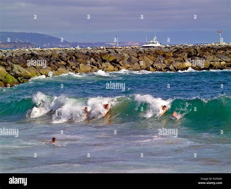 Bodysurfers ride Pacific Ocean surf at The Wedge on the Balboa ...