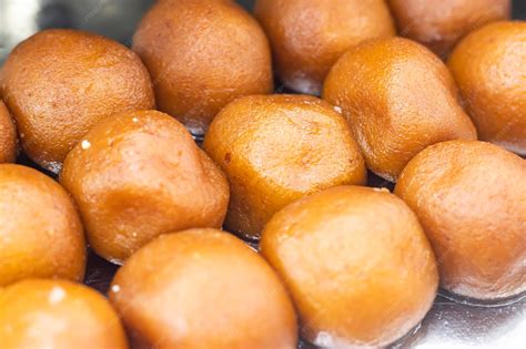 Lalmohan lal mohan or gulab jamun texture closeup side view of indian ...