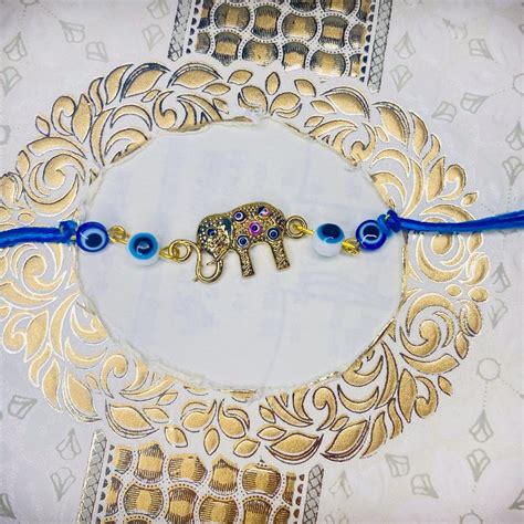 Mahi Evil Eye and Baby Elephant-Shaped Rakshabandhan Rakhi for Brother ...