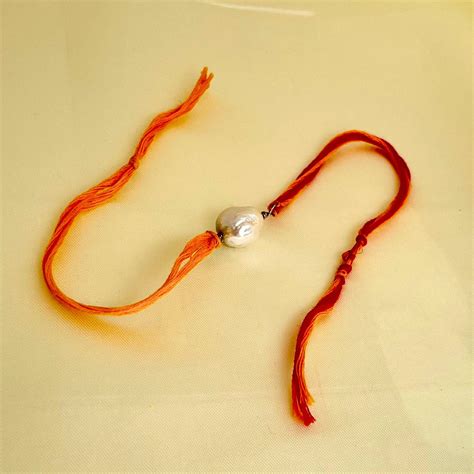 Buy Real Pearl Rakhi in 925 Silver & Mouli Thread Online- CherishBox ...