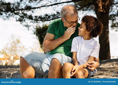 Little Boy Whispers To Lovely Girl In Ear. Happy Brother And Sister ...
