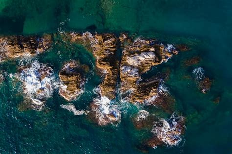 Aerial shots of the turquoise water, reef formations, beach and shipwreck at Henrietta Rocks.
