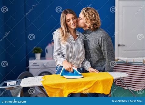 Man and Woman Couple Ironing Clothes Kissing at Laundry Room Stock ...
