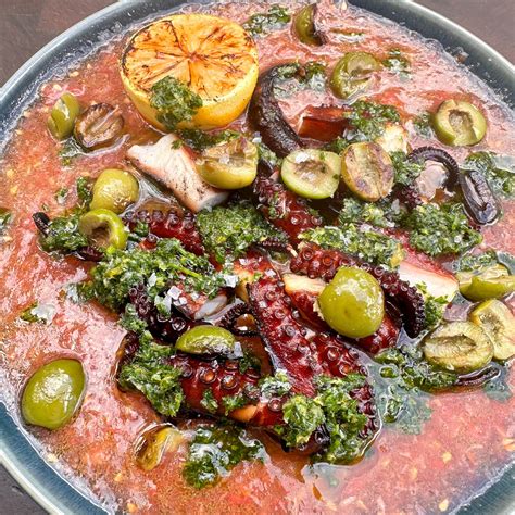 Smoked and Grilled Spanish Octopus with Olives and Tomates – Alchemy Grills