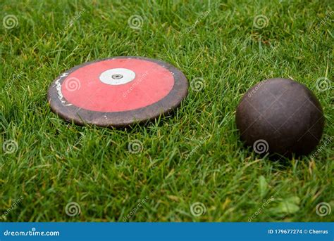 Discus and Shot Put Ball on the Grass Stock Photo - Image of shot ...