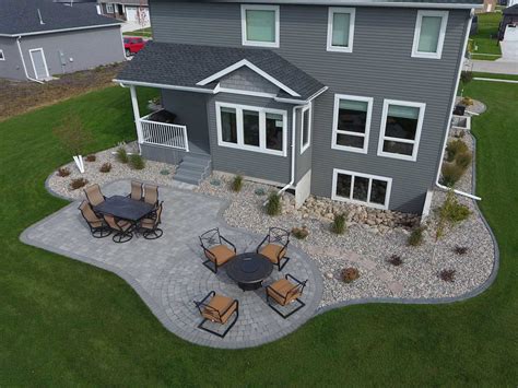 Gray Paver Patio with Edging, Rocks, and Plants - Oasis Landscapes