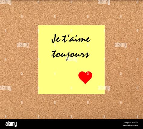 I love you always in French message on post it sticker on corkboard ...