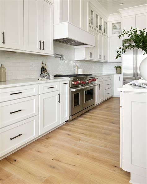 White Kitchen Cabinets Paired with Light Hardwood Floors | Kitchen ...