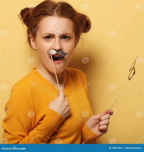 Young Woman with Fake Mustaches and Glasses Over Yellow Backgro Stock ...