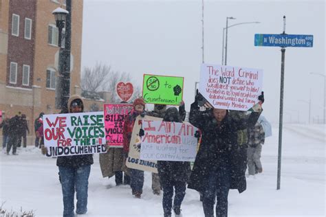 In Green Bay, marchers trek through falling snow to protest ICE ...