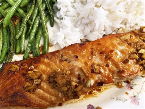 Close-up on salmon fillet with fruit salsa, over rice.