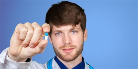 Young confident doctor man in medical gown | Premium Photo