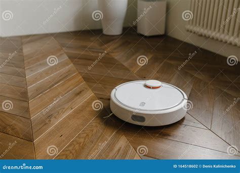 Robotic Vacuum Cleaner on Laminate Wood Floor Smart Cleaning Technology ...