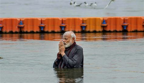 Modi takes holy dip at Sangam, washes feet of sanitation workers- The Week